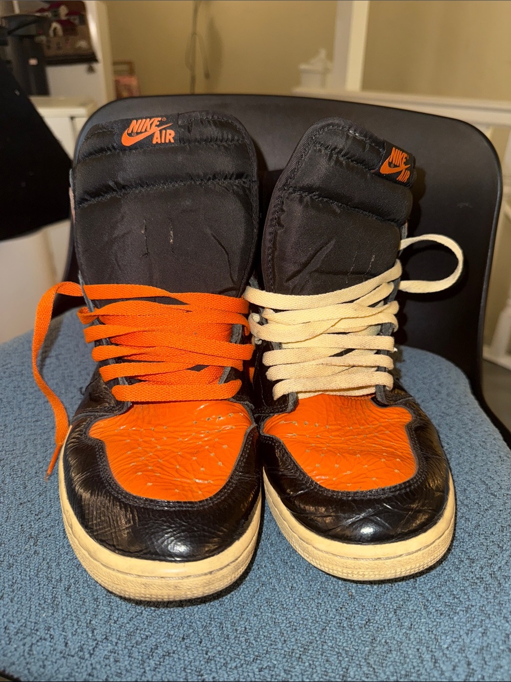 Jordan 1 Nike Black and Orange High-Top Sneakers with Mismatched Laces